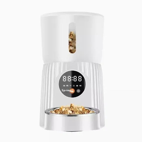 Black automatic pet feeder with digital display and food container showing portion control settings