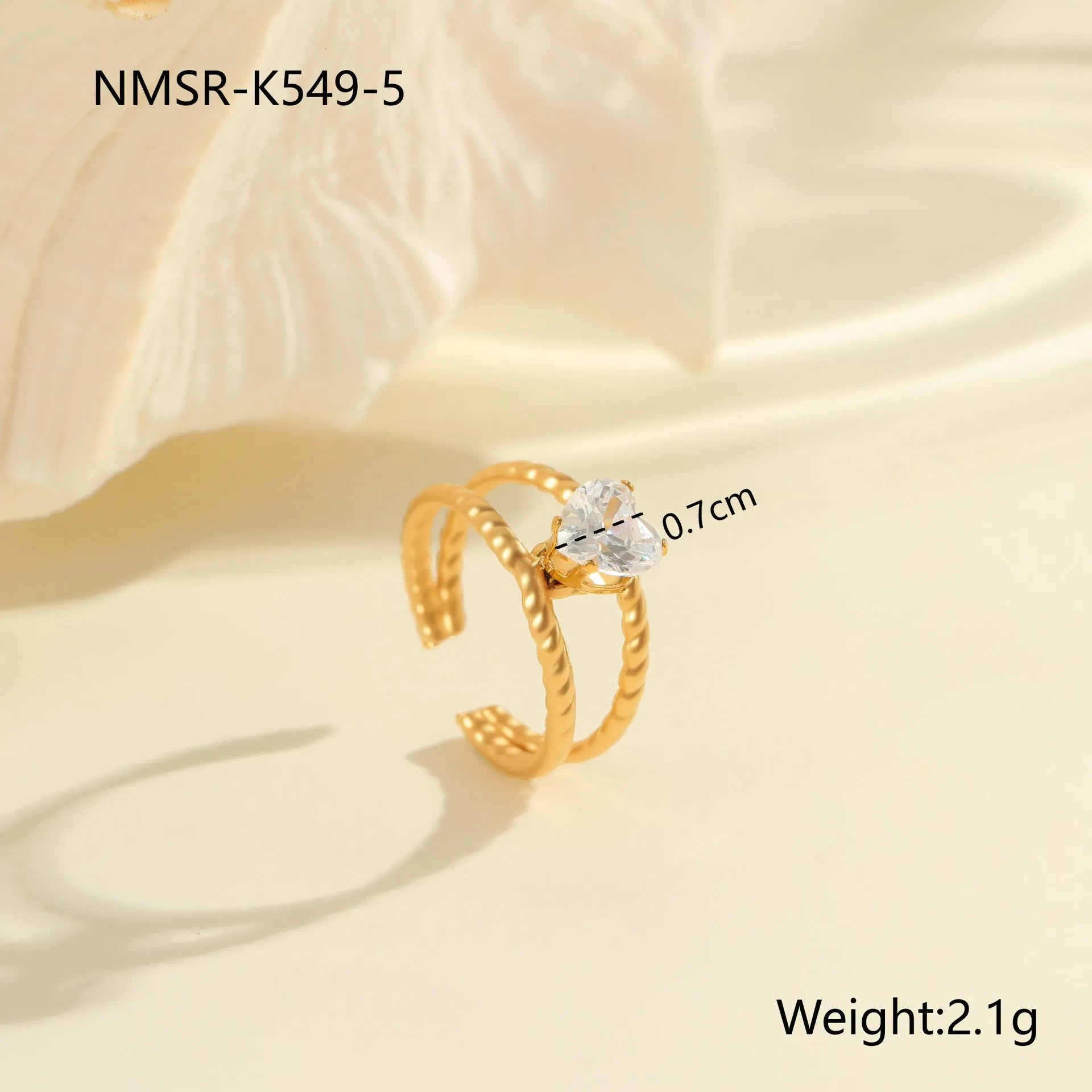 Gold-coloured adjustable stainless steel ring with zircon geometric shapes on white background.