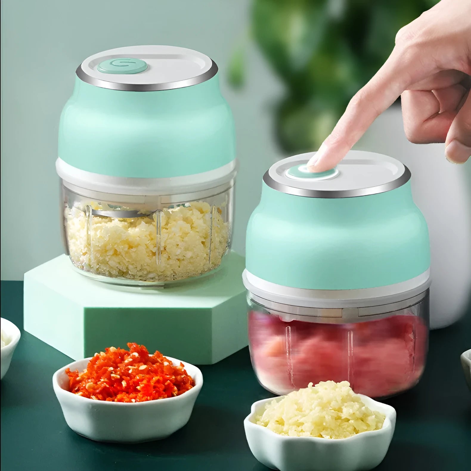 Green portable electric mini garlic cutter masher with transparent cup and USB cable, 150ml capacity on white background