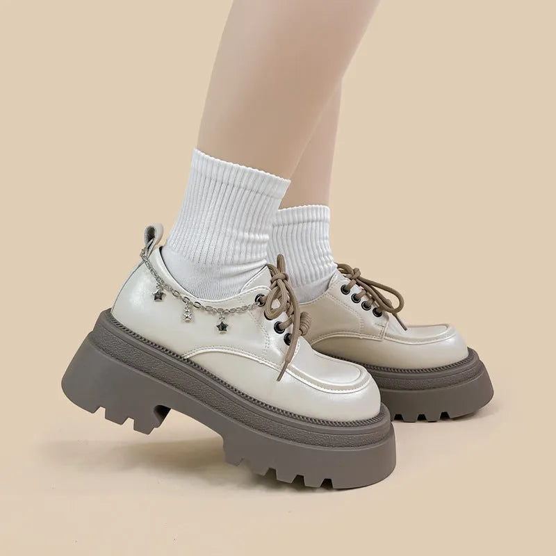 White women's platform Mary Jane shoes with a round toe, chunky high heel, and front lace-up detail.