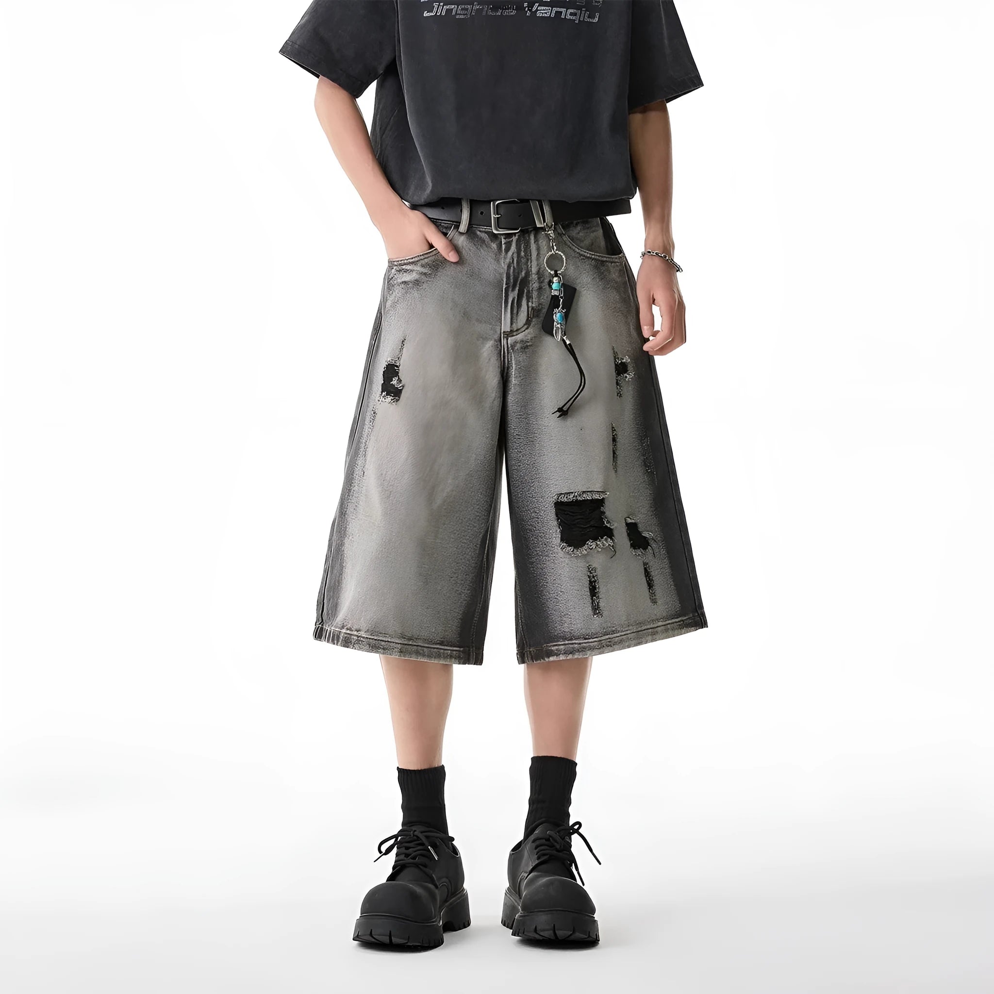 Grey cotton denim shorts with distressed hole finish and loose cropped fit