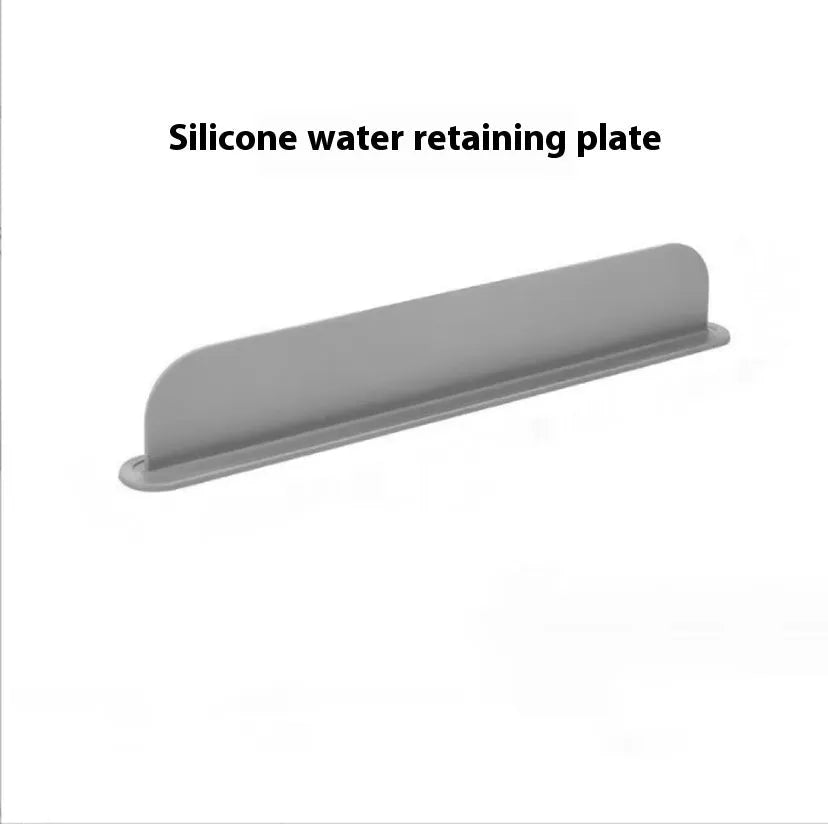 Grey silicone sink splash guard water blocking plate placed on a kitchen sink edge