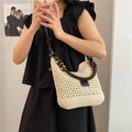 Knitted tote beach bag with contrast stitching showing crossbody strap and zip compartment