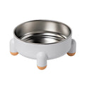 Green stainless steel pet bowl with a high foot and non-slip silicone base on a floor