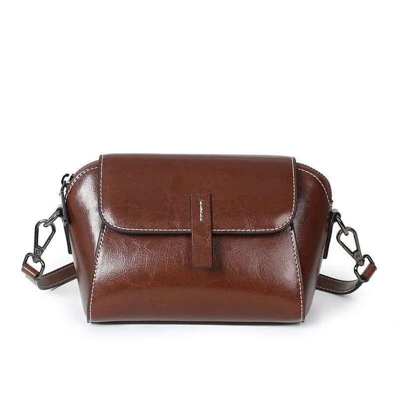 Women's brown oil wax leather messenger bag with cross-body strap and multiple internal compartments