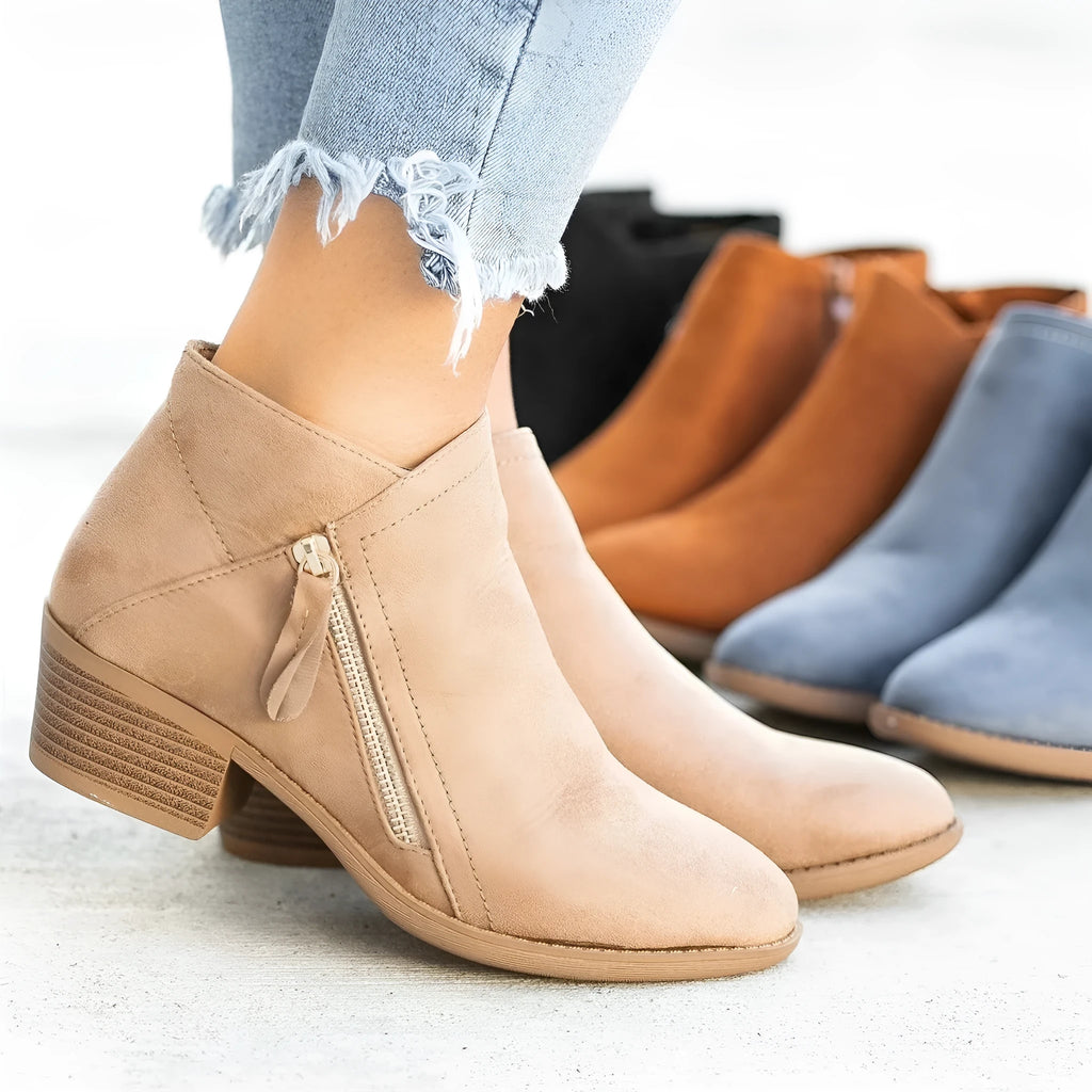 Blue suede women's ankle boots with a chunky heel and side zip closure on a white background.