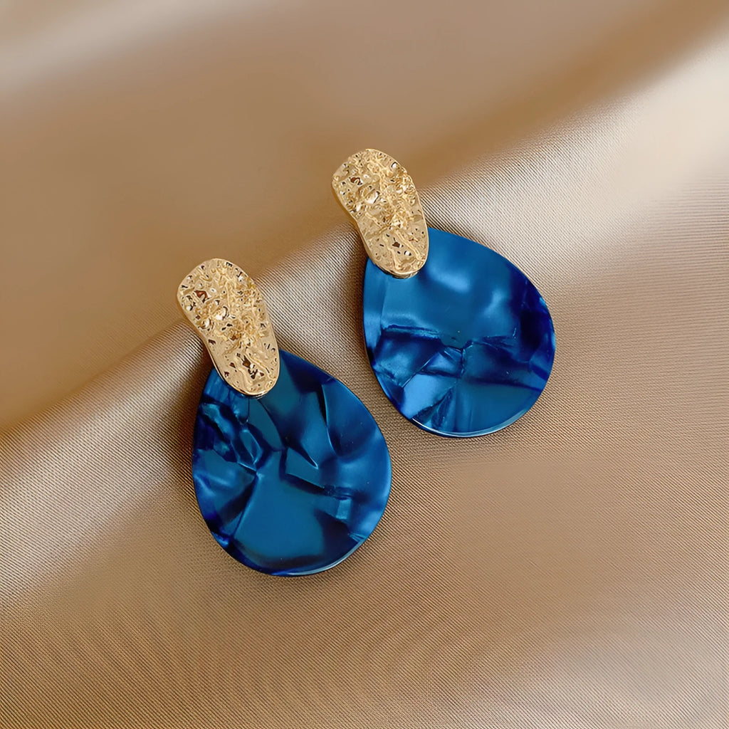 Silver Needle blue acrylic water drop ear studs with pleated texture on white background