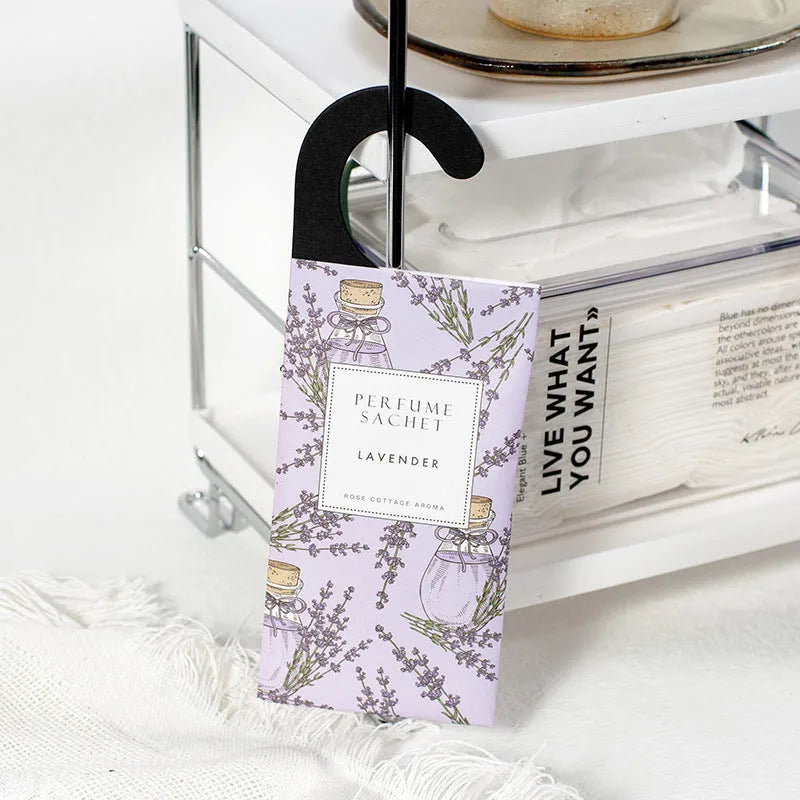 Five 30g lavender and rose scented wardrobe sachets on a shelf, each measuring 21x8cm