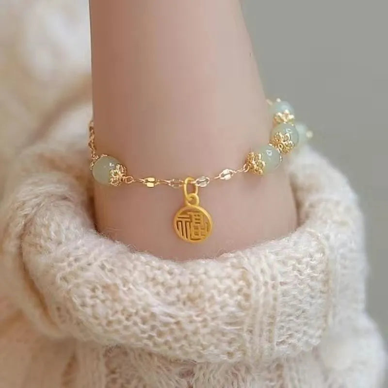 Chinese style glass bracelet with bamboo joint details in a red Lvzhu Duobao design.