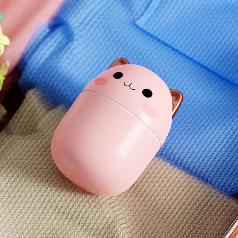 Cute cat-shaped USB air humidifier with LED cool mist spray in white, for office and bedroom use.