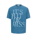 Man wearing a blue loose-fit American retro t-shirt with a white letter print design.