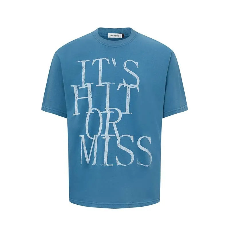 Man wearing a blue loose-fit American retro t-shirt with a white letter print design.