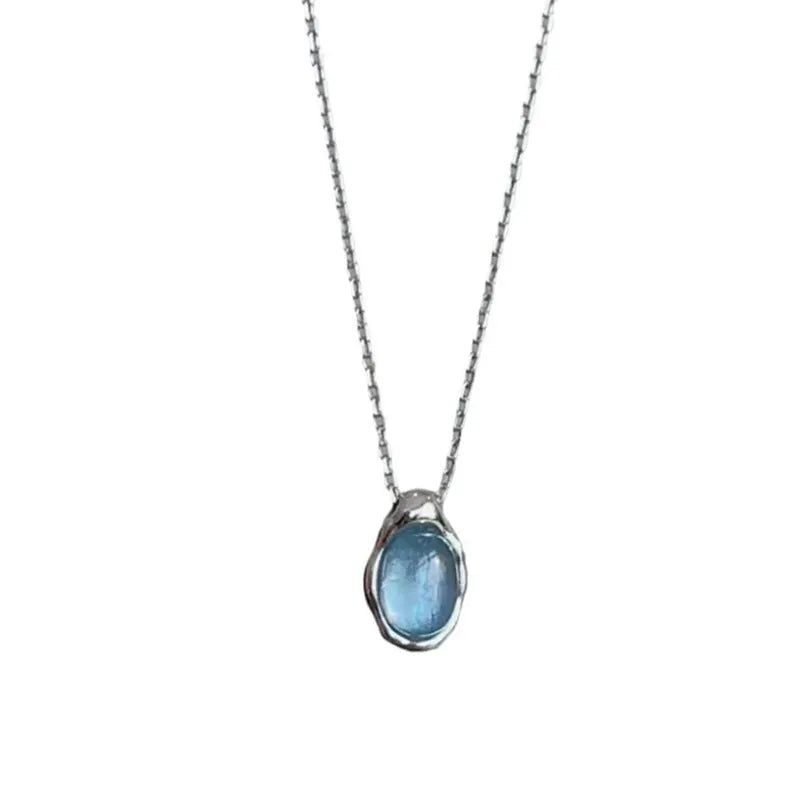 Navy blue water drop geometric pendant necklace with cross chain on white background