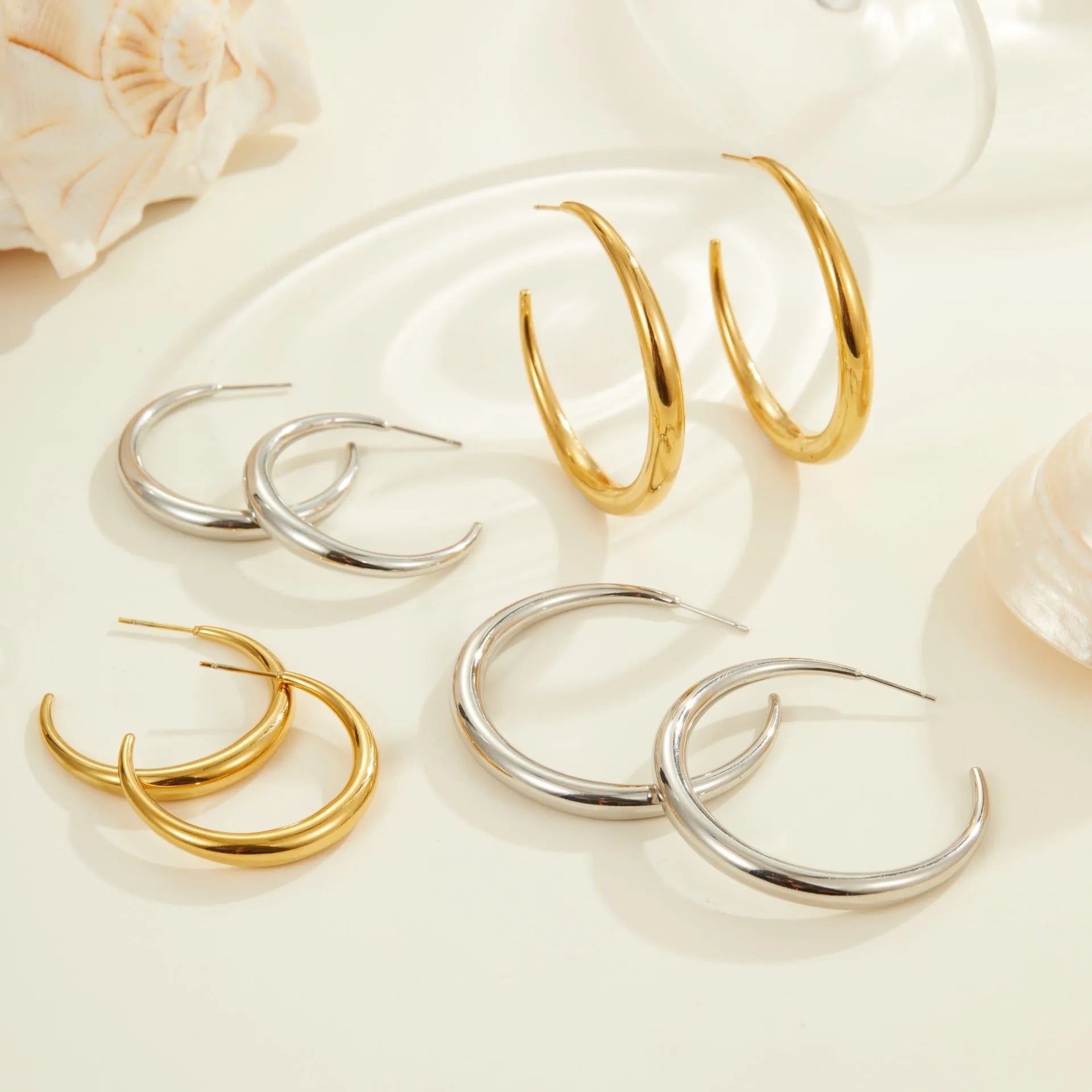 Geometric round titanium steel hoop earrings in gold and stainless steel finishes, small and large sizes