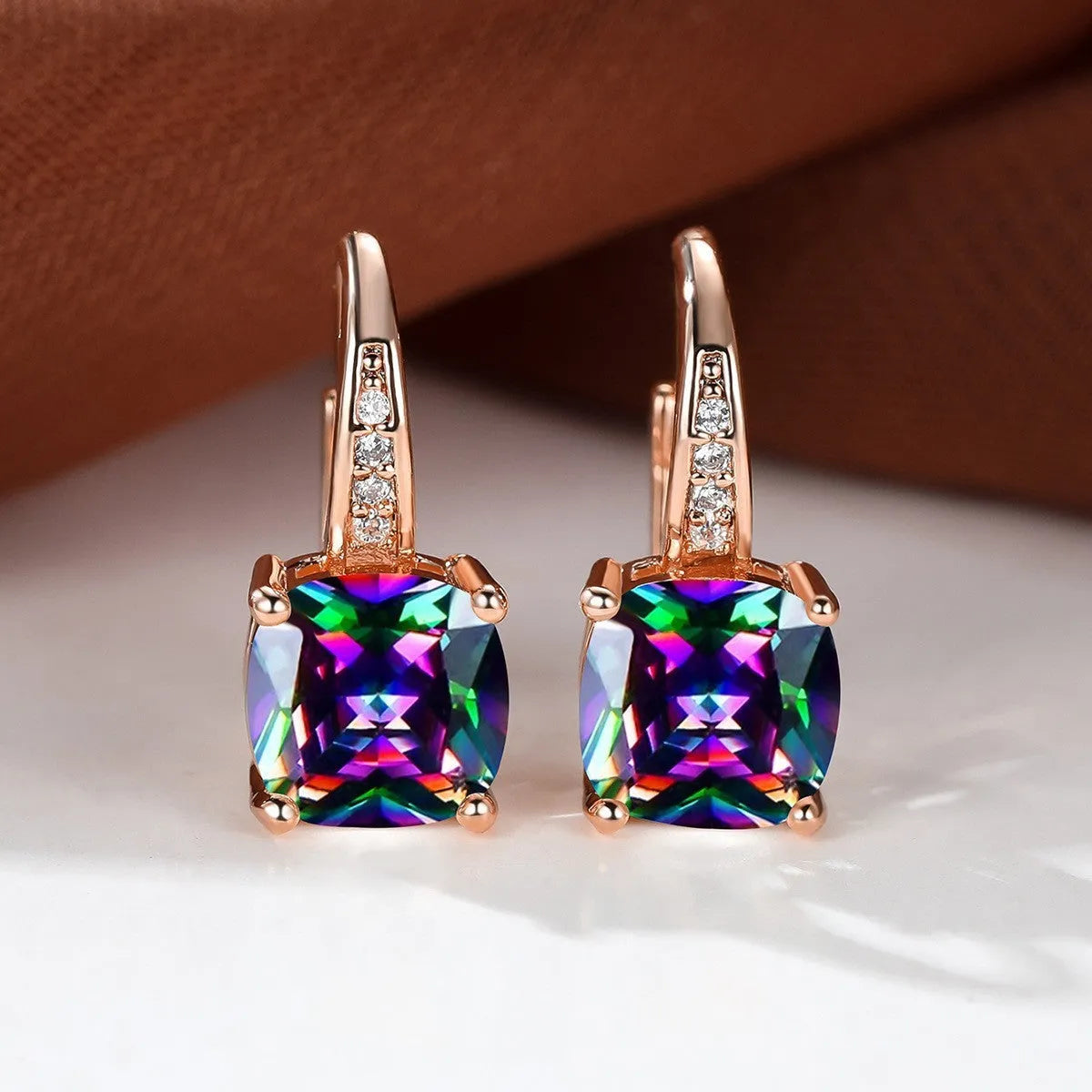 Square geometric ear hook studs with a round zircon stone, shown in a gold electroplated finish.