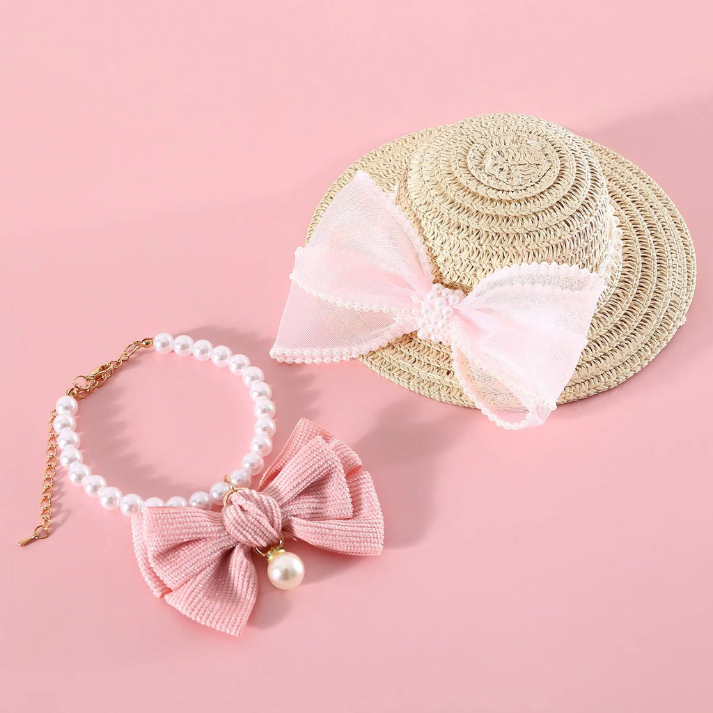 Cat wearing a woven straw hat with a pearl bow decoration in a princess style.