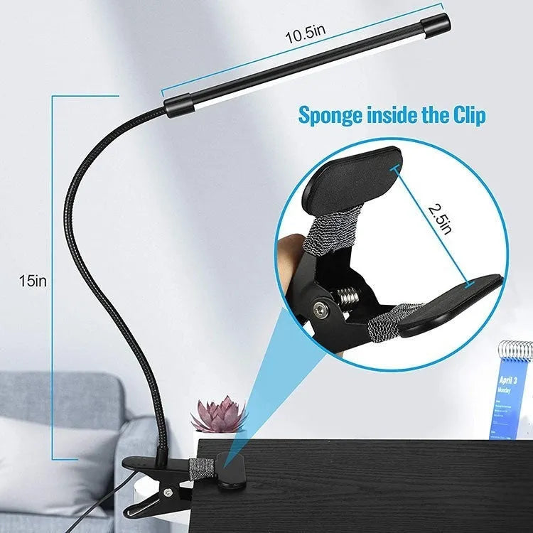Black and white 26cm USB-powered LED desk lamp on a desk for study lighting.