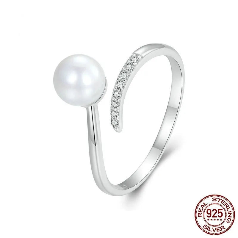 Open loop adjustable sterling silver ring with a white shell pearl.