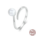 Open loop adjustable sterling silver ring with a white shell pearl.