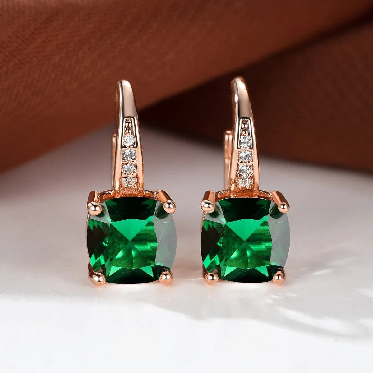 Square geometric ear hook studs with a round zircon stone, shown in a gold electroplated finish.