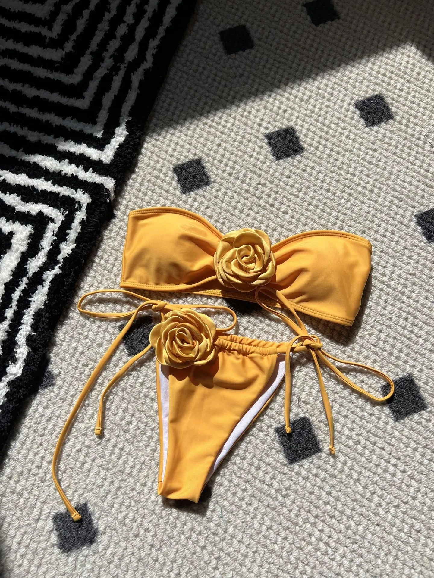 Women's solid colour drawstring tube top and bikini brief swimsuit set on a mannequin.