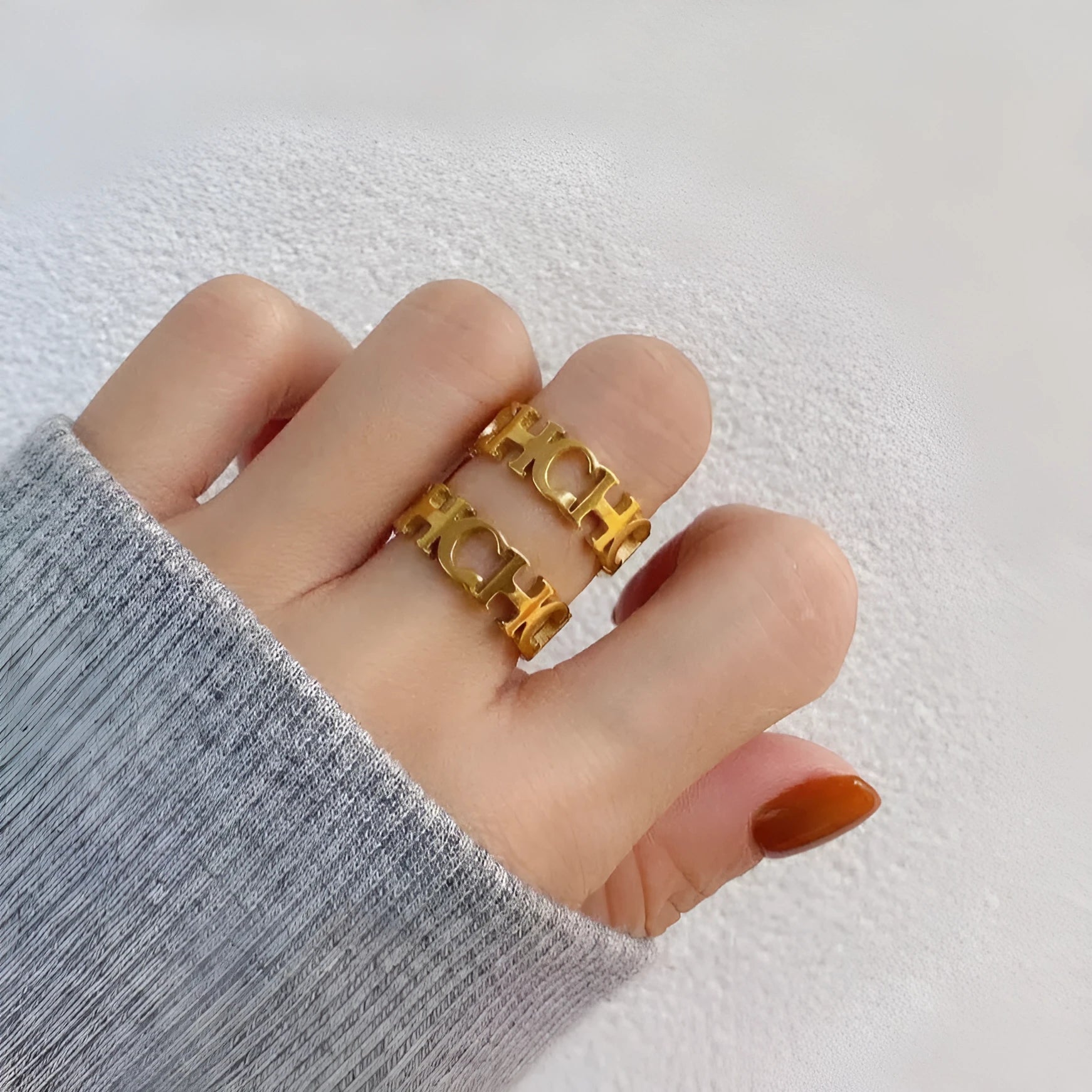 Gold titanium steel hollowed cut letter ring in unisex geometric Korean style, sizes 6-9