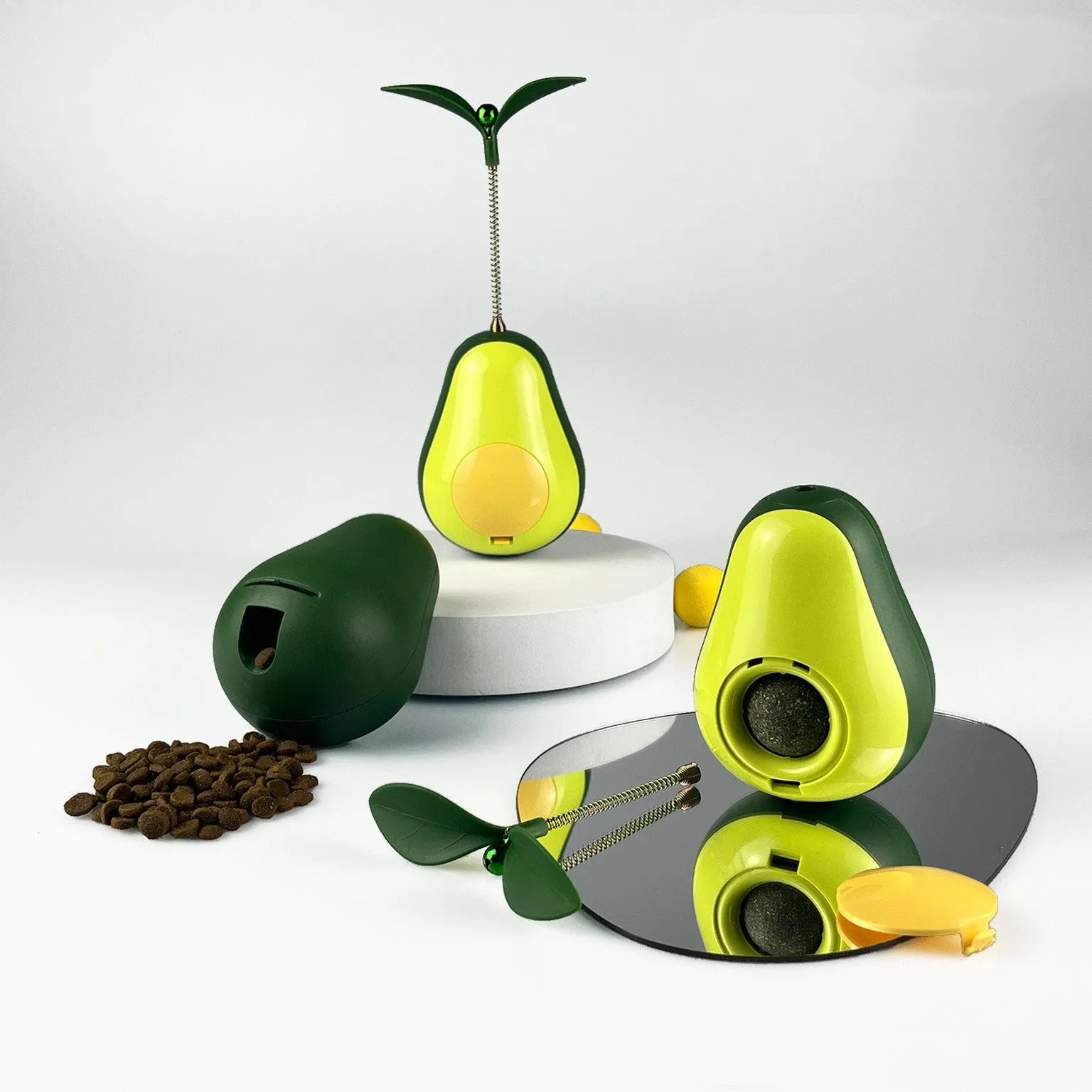 Green silicone avocado-shaped cat toy tumbler with treat dispensing opening, 80x80x107mm size
