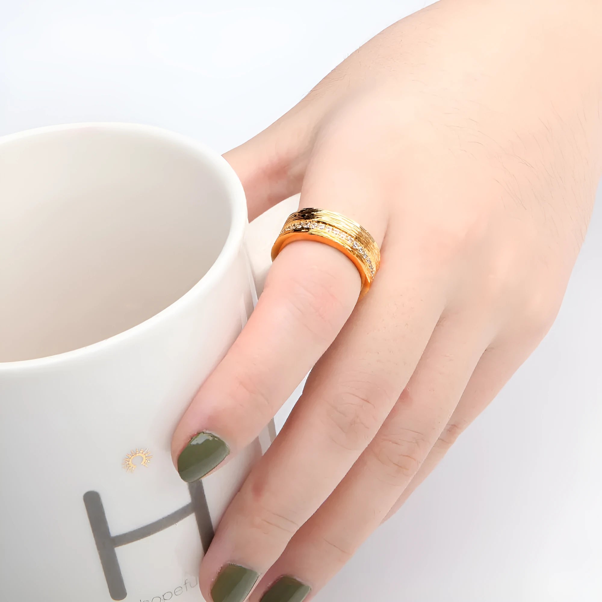 Gold geometric women's ring with clear zircon stone on copper band.