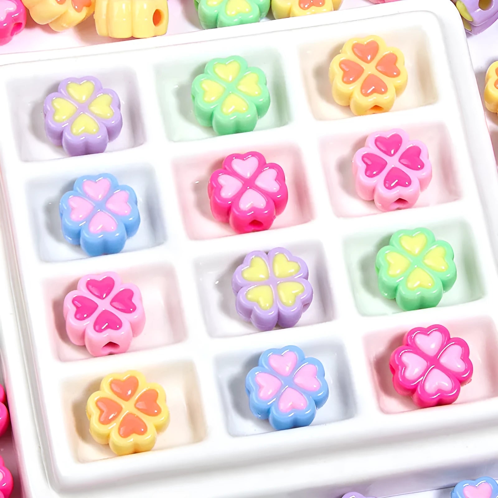 Assortment of 15mm frosted acrylic four-leaf clover beads in rose red, pink, yellow, green, blue, and purple colours.