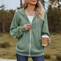 Green women's hooded zipper coat with a loose casual fit on a hanger