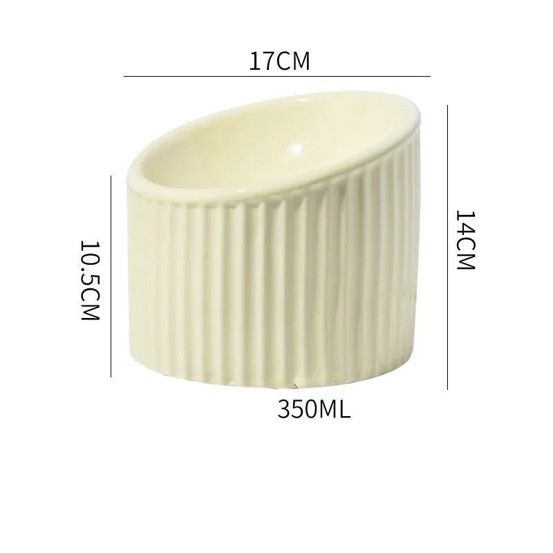Elevated ceramic cat bowl in green, showing tilted design and raised height for feeding.