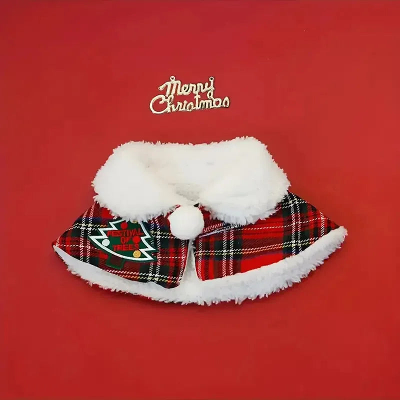 Polyester pet scarf cloak on a dog, showing a red background with a festive snowflake bell design.