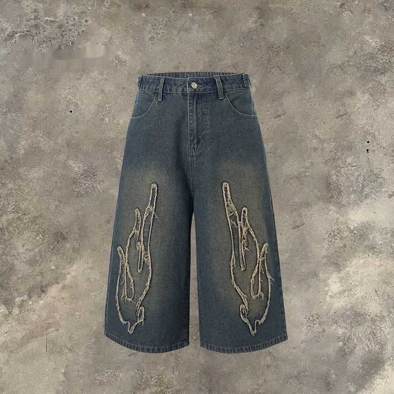 Men's black denim shorts with flame embroidery and patch detailing in straight cut design