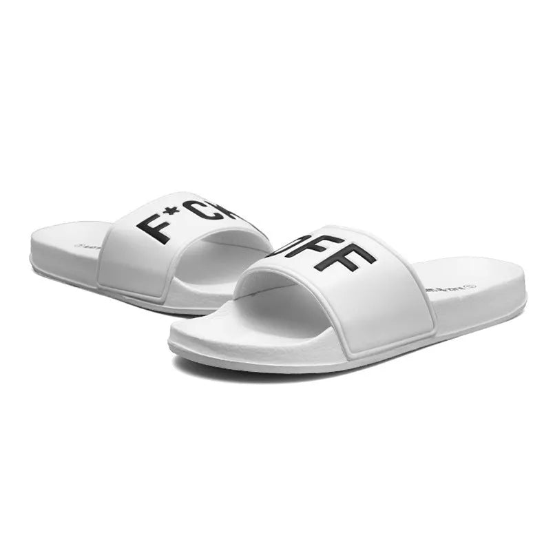 Men's black open toe slippers with a rubber sole on a wooden floor.