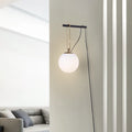 Contemporary clear glass wall light fixture with modern design on a white wall.