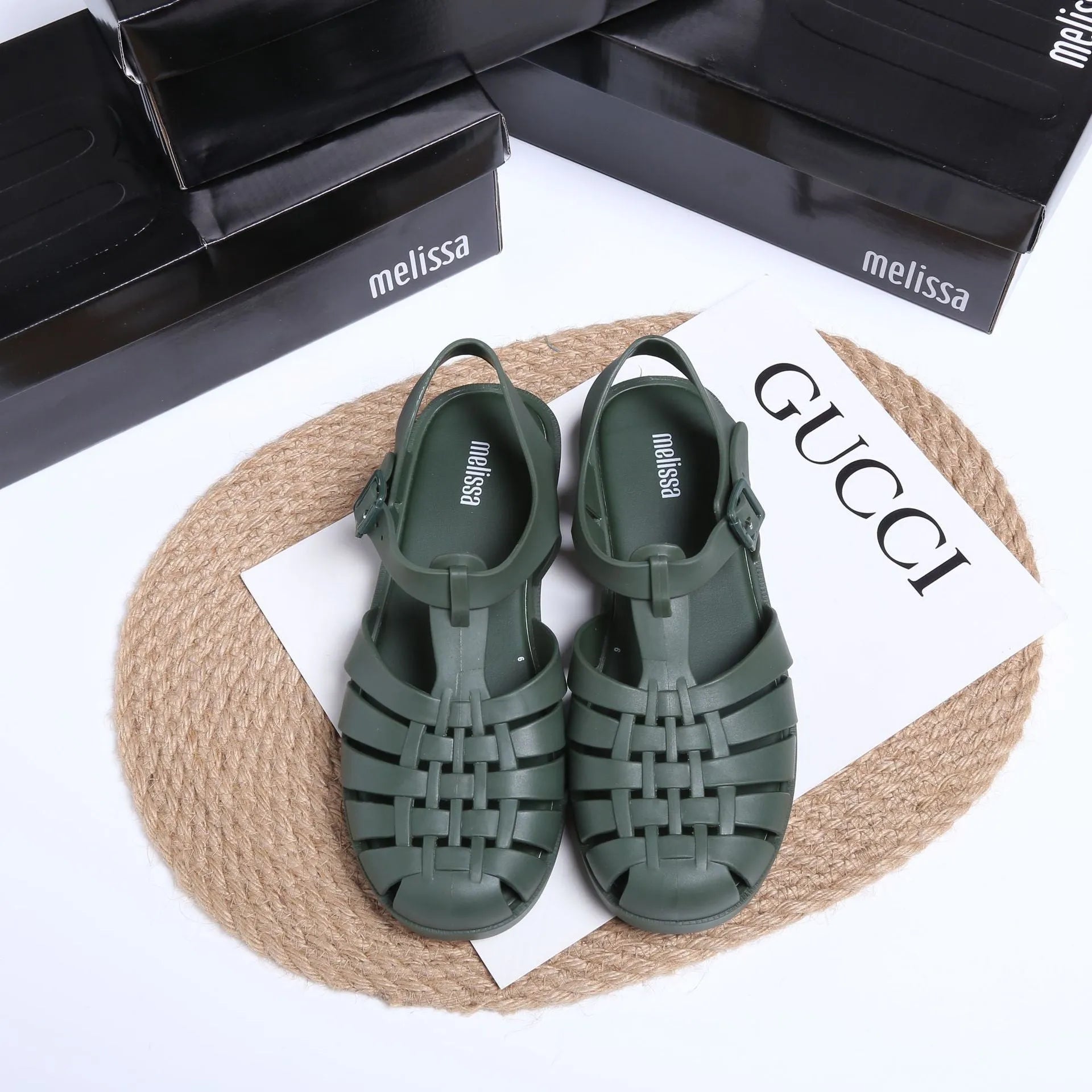 Black Roman-style sandals with buckle fastening and hollow-out design on low-top PVC upper