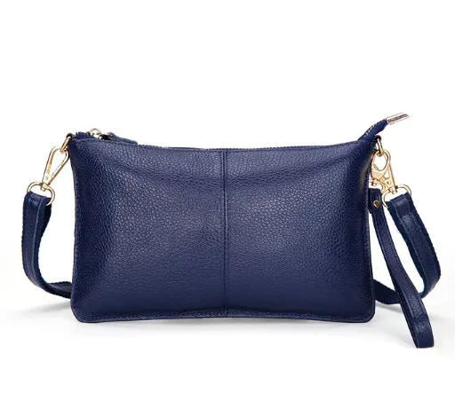 Structured cowhide lady slant bag in apricot colour with hand strap and shoulder strap, showing slim profile.