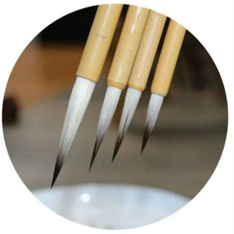 Set of four lower case writing brushes with thin gold body and mixed hair tip in pine branch colour for calligraphy