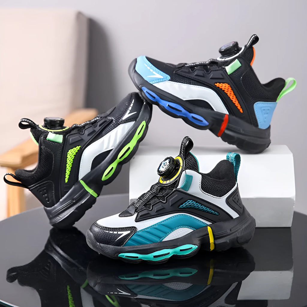 Children's waterproof leather basketball shoes with rotating buckle, black and grey colour, on natural lawn