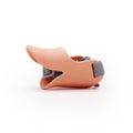 Silicone duckbilled dog muzzle in yellow on a small dog with adjustable strap