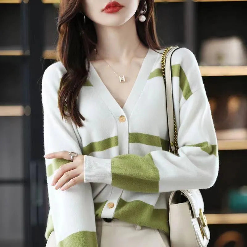 Women's black and white striped V-neck knitted cardigan with 3D pattern on a hanger.