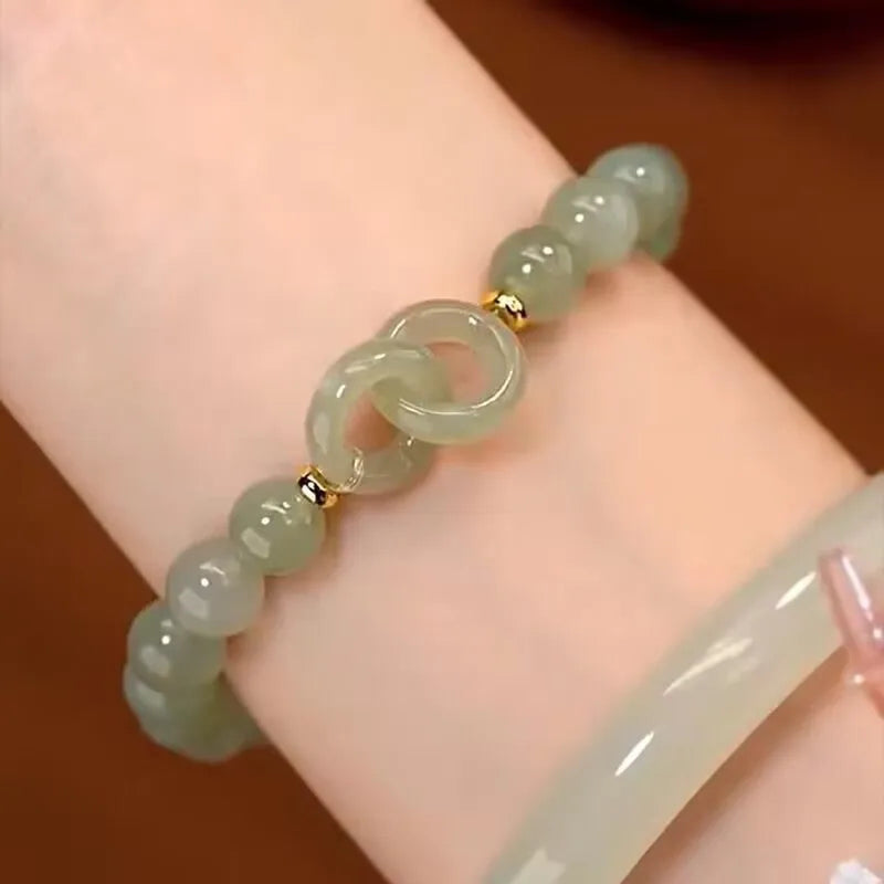 Chinese style glass bracelet with bamboo joint details in a red Lvzhu Duobao design.