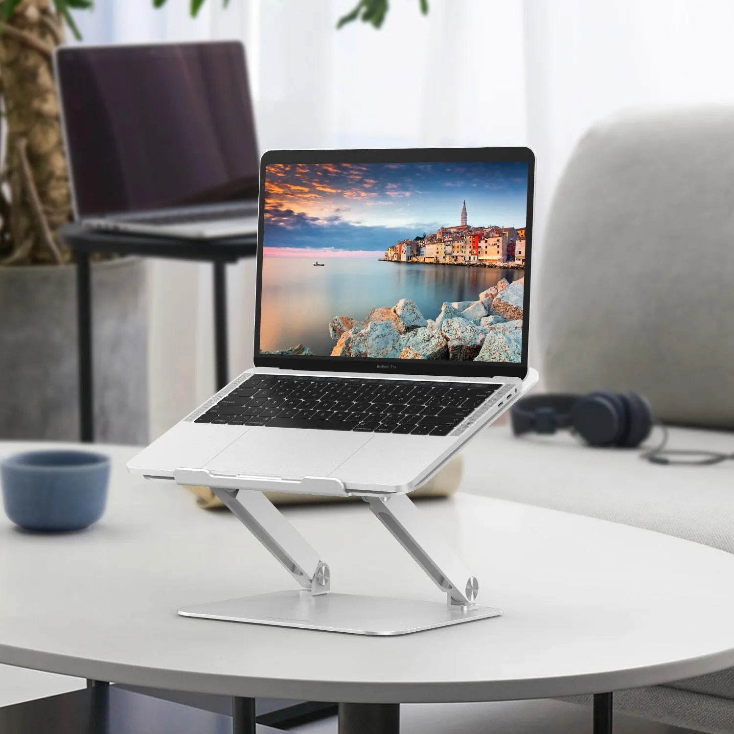 Aluminium alloy multi-angle notebook stand in space grey on a desk with a laptop