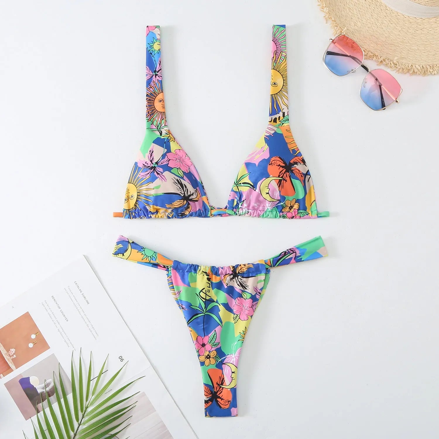 Women's blue floral print bikini top and briefs set on a white background