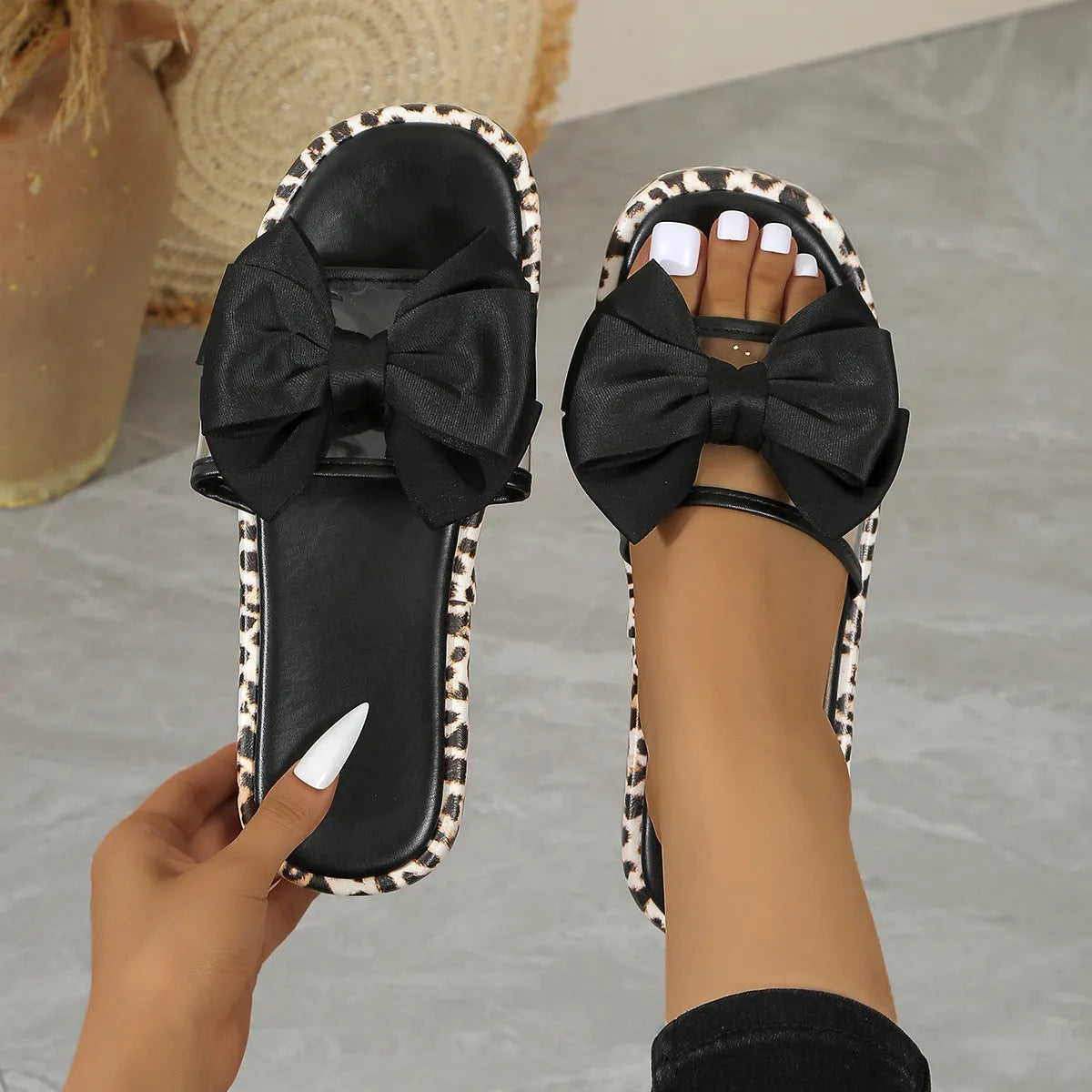 Women's black and white leopard print beach slippers with a thick platform sole.