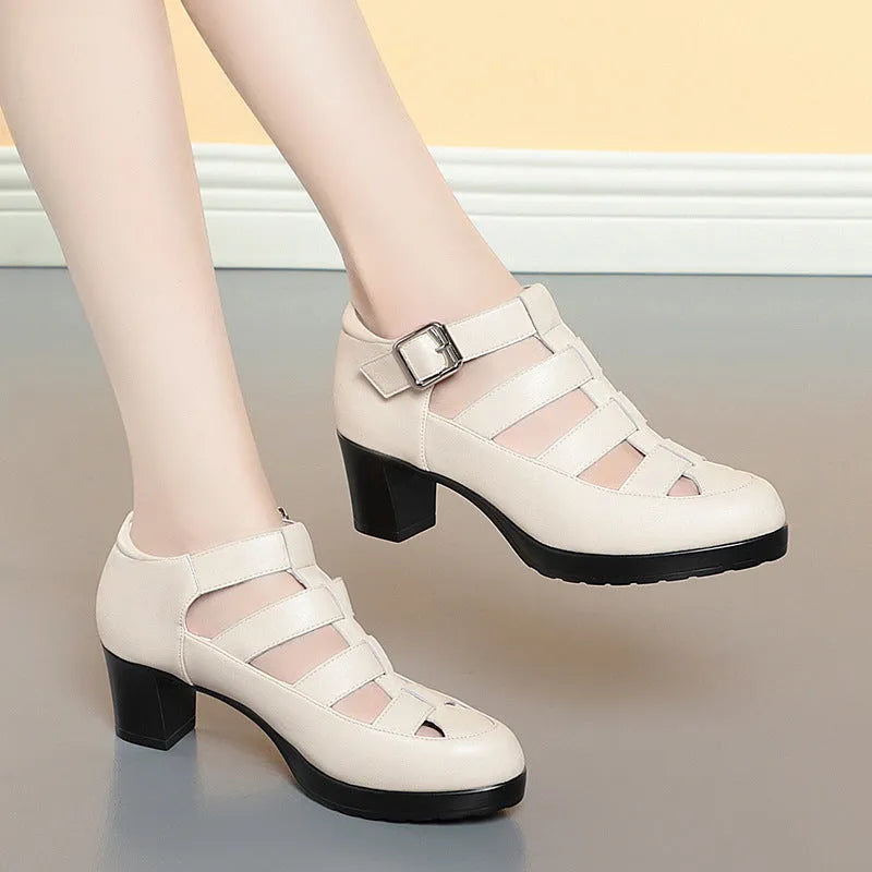 Women's beige closed toe sandals with chunky heel, ankle strap, buckle, and back zipper.