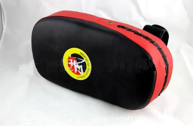 Muay Thai foot target pad in PU leather with black and blue colour scheme showing curved face and Velcro strap