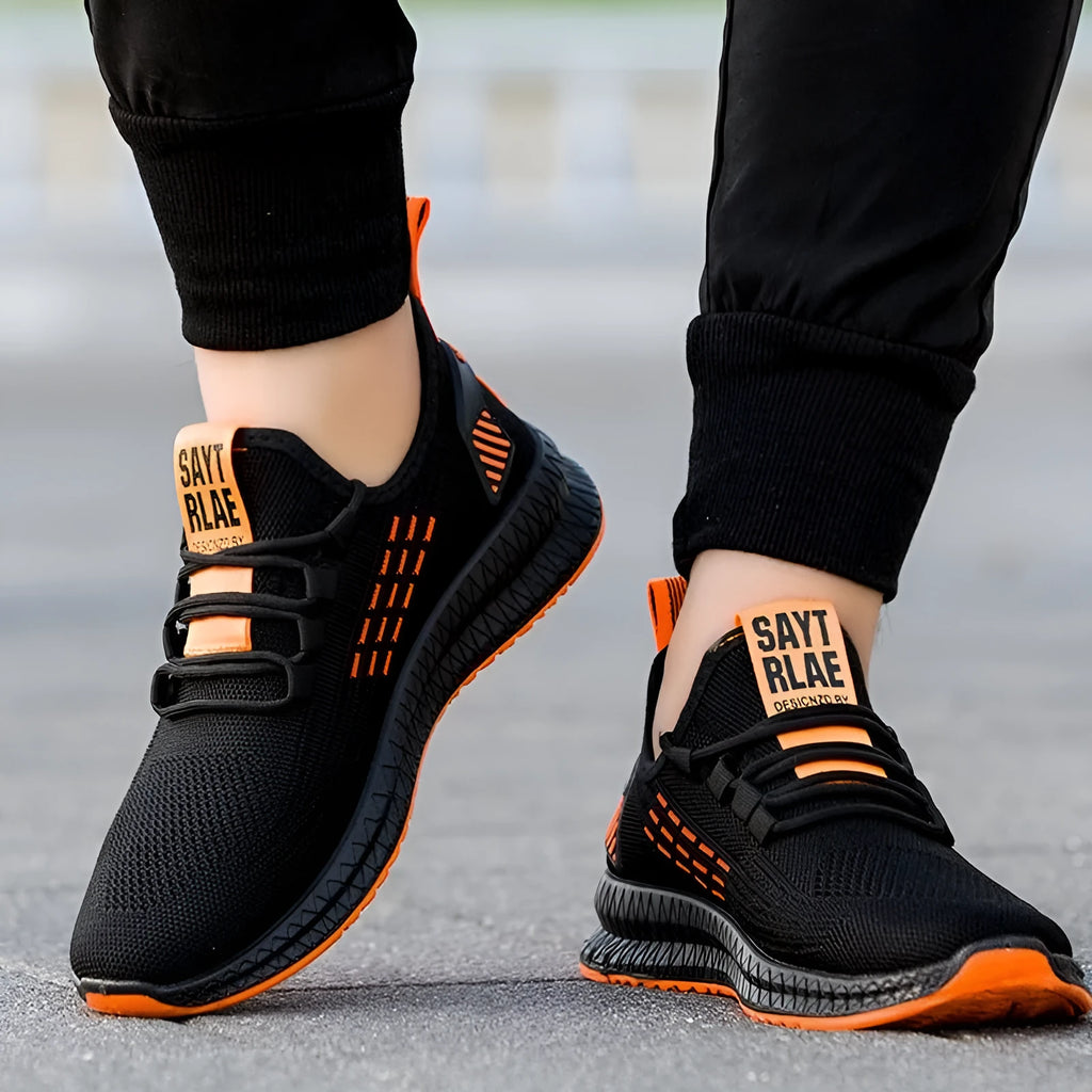 Men's low-top casual trainers with Flying Weave upper, cross straps, and striped pattern in black, orange, or yellow.