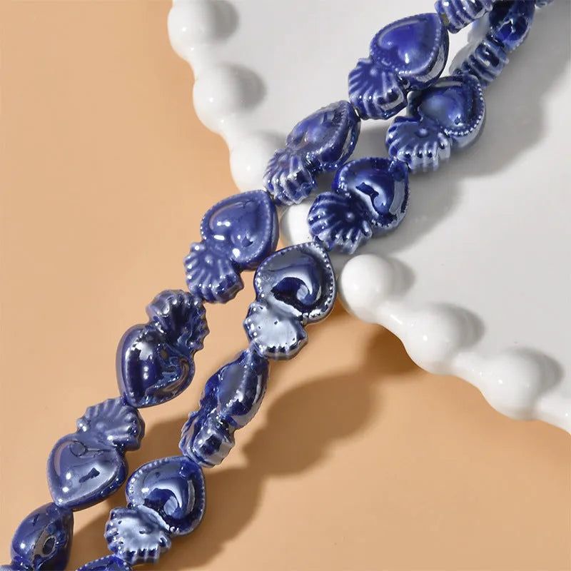 Ceramic heart torch beads in various colours for jewellery making, approximately 10mm by 15mm with straight hole