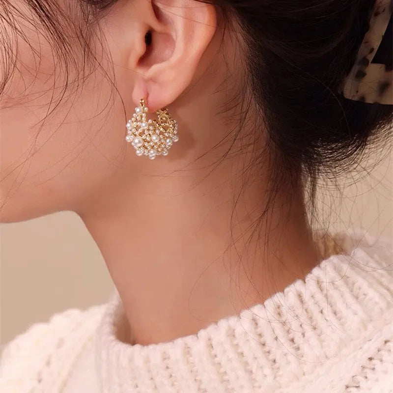 Gold floral basket-shaped women's earrings made from small rice beads with pearl inlay on copper.